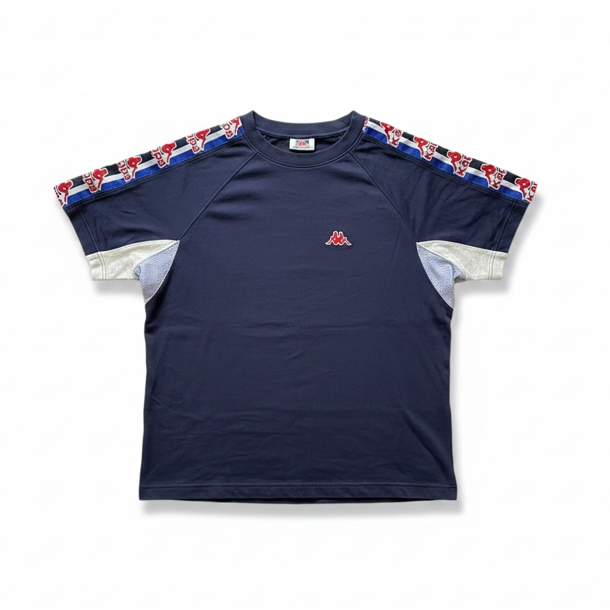 A navy blue short-sleeve athletic t-shirt with a red, white, and blue patterned stripe running along the shoulders and sleeves, and a small red embroidered logo on the left chest, shown flat on a white background.