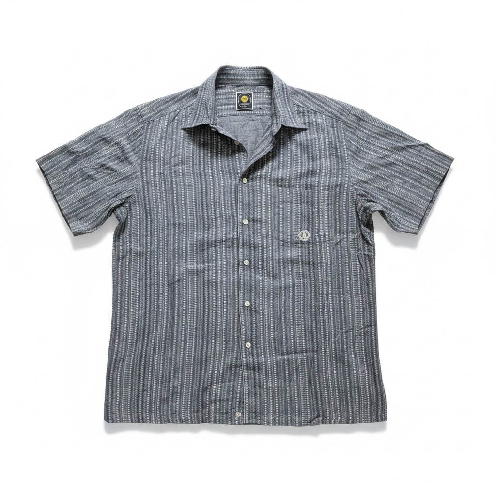 A short-sleeve button-up shirt with vertical gray and white stripes, featuring a pointed collar, white buttons, and a small circular logo on the left chest pocket.
