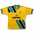 A vintage yellow Adidas football jersey with teal and black diagonal stripes, featuring the Opel logo on the front and the VfB Wolfsburg club crest on the chest.