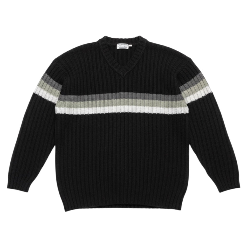 A black ribbed knit sweater with a V-neck and horizontal stripes across the chest and upper sleeves in shades of gray, beige, and white.
